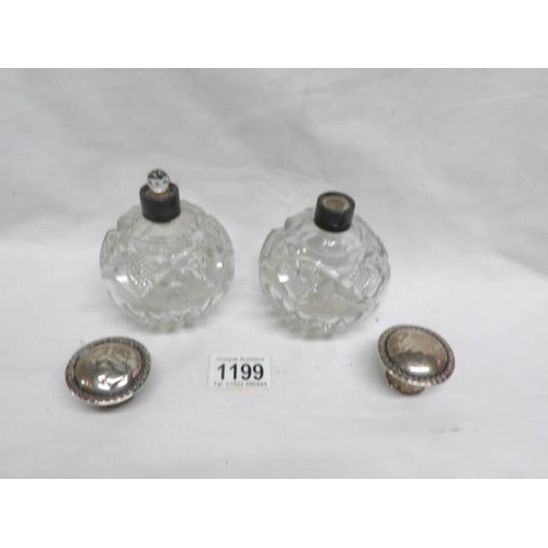 1199 - A pair of cut glass scent bottles with silver tops