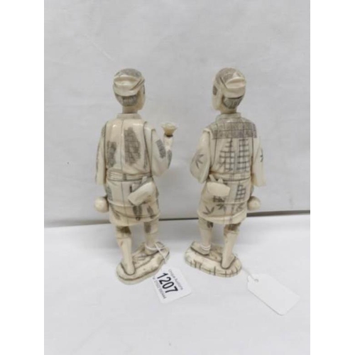 1207 - A pair of carved ivory figures