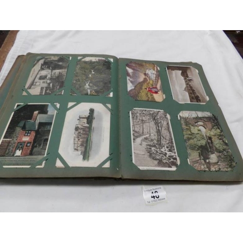 48 - An Edwardian postcard album containing approximately 200 post cards