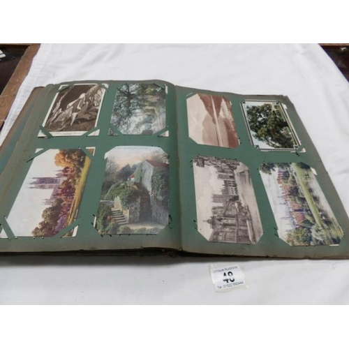 48 - An Edwardian postcard album containing approximately 200 post cards