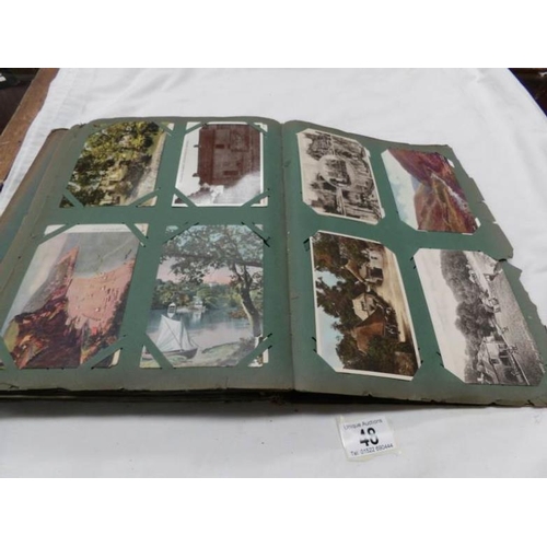 48 - An Edwardian postcard album containing approximately 200 post cards