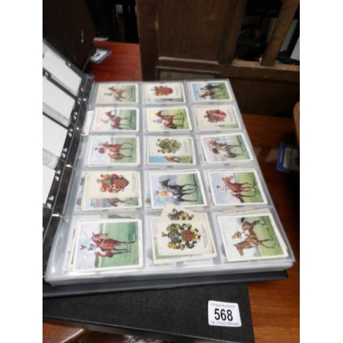 568 - A large album of mainly cigarette cards including silks and some reprints