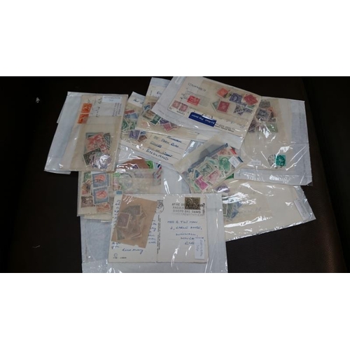 152 - A box of assorted loose stamps and an album of stamps