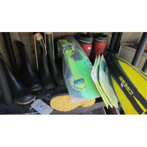 104 - A quantity of wellington boots, flippers etc