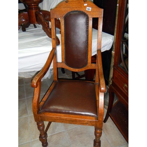 1801 - An Edwardian oak carver chair with leather seat and back panel