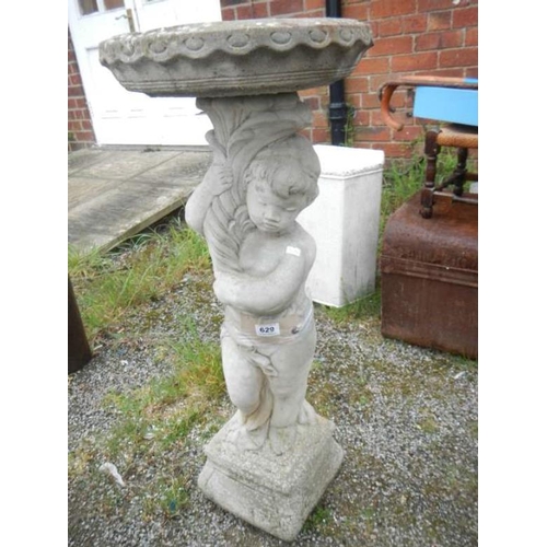 629 - A concrete figure birdbath