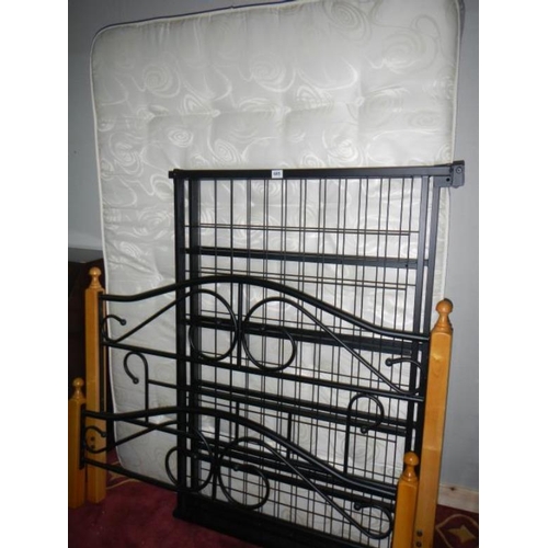 685 - A 4' 6'' metal bedstead and matress