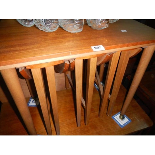 692 - A nest of teak side tables