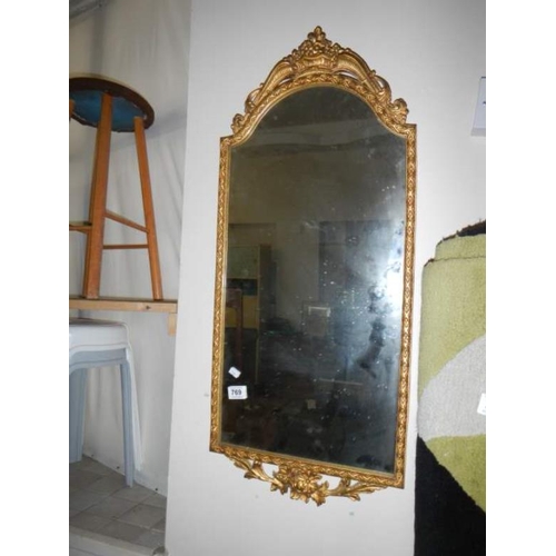 769 - An old metal framed mirror