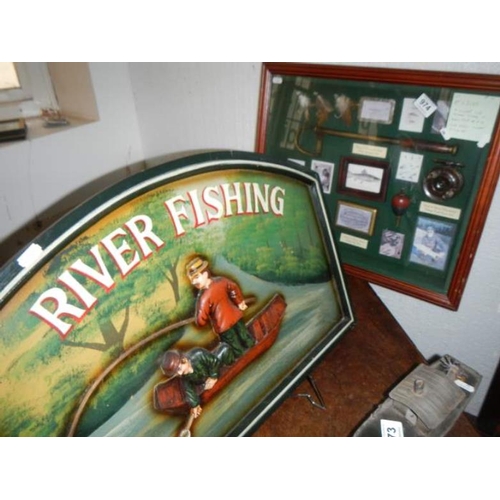 974 - A cased fishing display cabinet including reels, flies etc and a advertising board