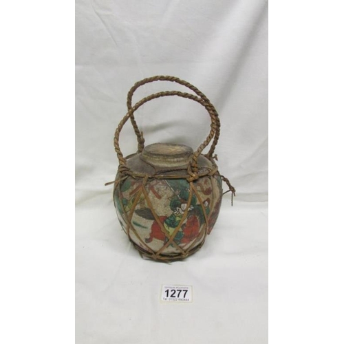 1277 - A 19th century Chinese ginger jar, sealed and with original contents and carrying handle