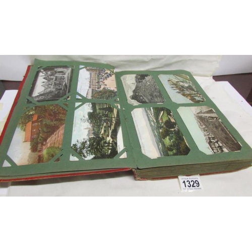 1329 - A red postcard album containing in excess of 250 postcards including Landscapes, Bamforth, Greeting ... 