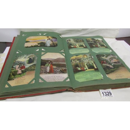 1329 - A red postcard album containing in excess of 250 postcards including Landscapes, Bamforth, Greeting ... 