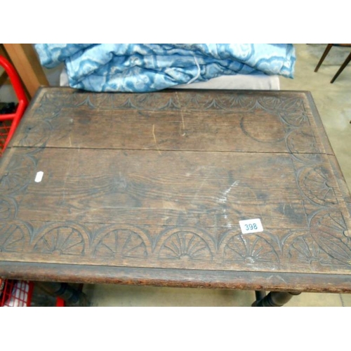 398 - A carved oak side table