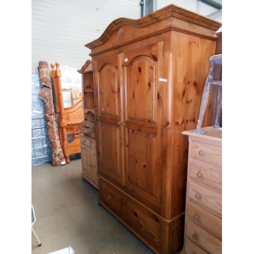 459 - A pine double wardrobe with drawers