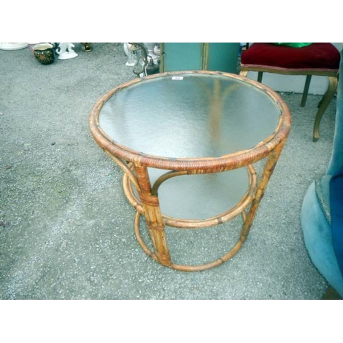 69 - A glass topped round bamboo table