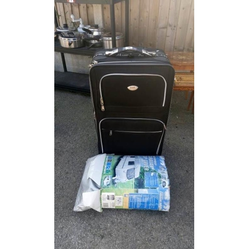 14 - A large suitcase & a caravan top cover