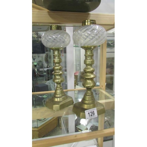 126 - A pair of Victorian brass candlesticks with vaseline glass peg fonts