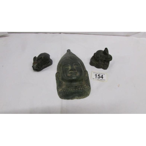 154 - A Chinese bronze Buddhist face and 2 small bronze rabbits