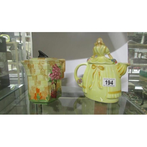 194 - A sundial teapot reg no. 826924 and a crinoline lady teapot