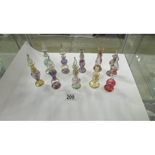 209 - 10 coloured glass perfume bottles (1 missing stopper)