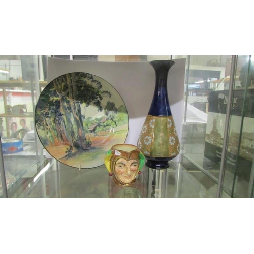 224 - A Royal Doulton saltglaze vase, a jester jug and a series ware plate