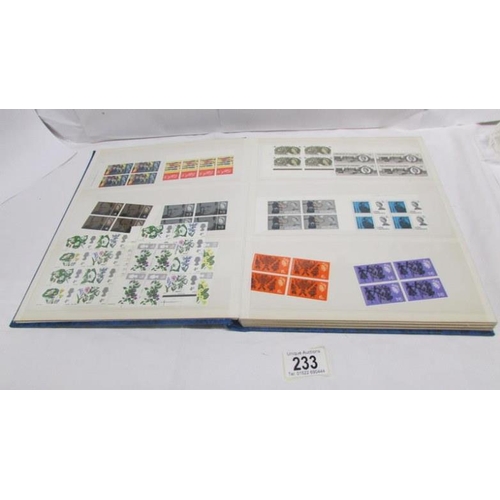 233 - An album of mint Elizabeth II pre-decimal stamps including definitives and commemorative, mainly in ... 