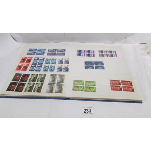 233 - An album of mint Elizabeth II pre-decimal stamps including definitives and commemorative, mainly in ... 