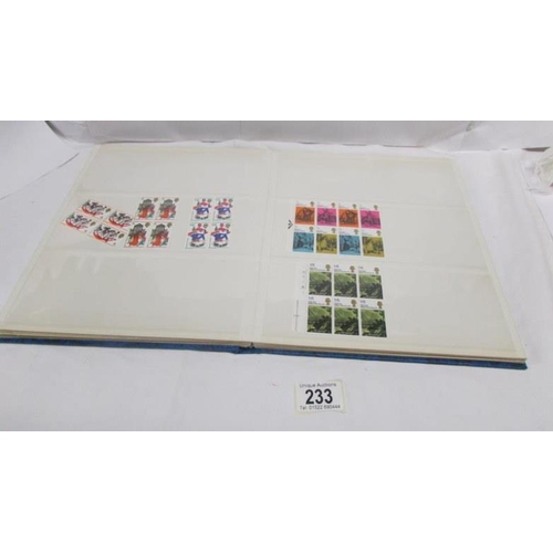 233 - An album of mint Elizabeth II pre-decimal stamps including definitives and commemorative, mainly in ... 