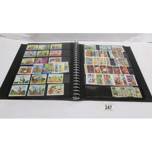 247 - An album of mainly mint Disney stamps, Angilla, Belize, Dominica, Grenada etc, mainly in sets