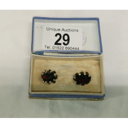 29 - A pair of vintage garnet ear studs set in silver, garnets in good colour