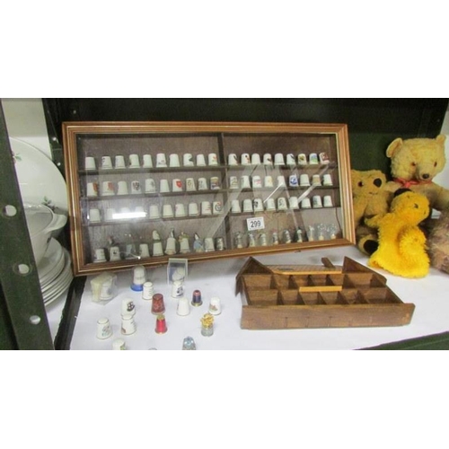 299 - A quantity of collector's thimbles in display cabinets