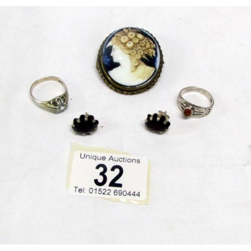 32 - A pair of silver garnet earrings, 2 silver rings and an unusual cameo brooch