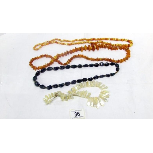 36 - 2 yellow amber necklaces, a vintage mother of pearl necklace and a lace agate necklace