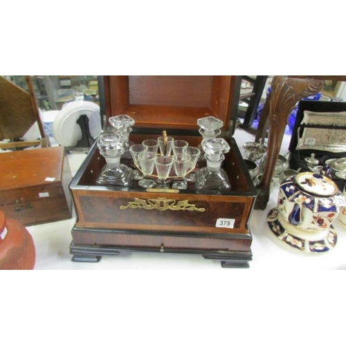 375 - A 20th century continental style drinks cabinet with 4 decanters and 14 glasses