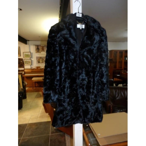 686 - A faux fur jacket, size 10 petite