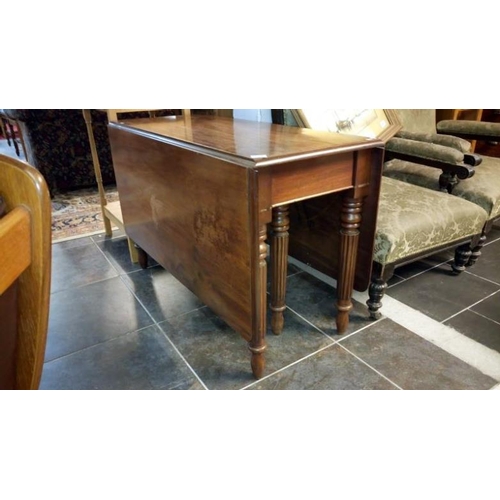 738 - A 19th century mahogany drop leaf table on reeded legs