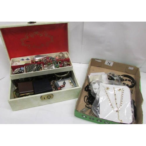 74 - A white jewellery box of costume jewellery together with a tray of mostly black costume jewellery