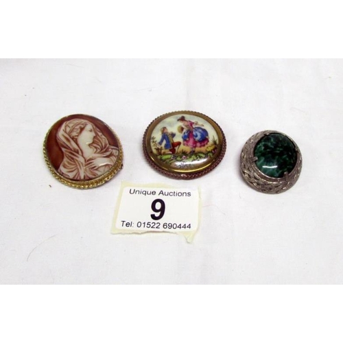 9 - A vintage Limoges brooch depicting a frolicking couple, a cameo brooch and one other