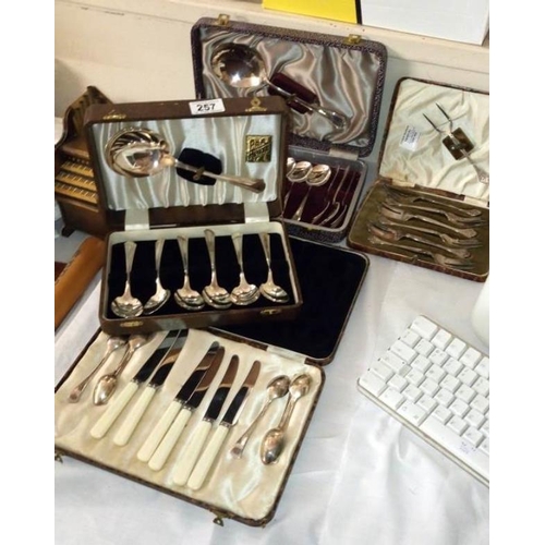 257 - 4 boxes of spoons fish vaults/ knives etc