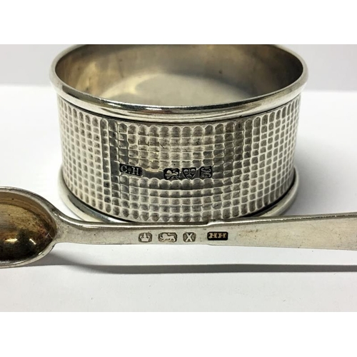 56 - A silver napkin ring, silver sugar nips and silver relief head brooch