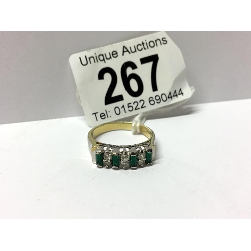 267 - A white metal dress ring set with green and white stones