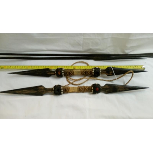 558 - A quantity of 1920's/30's ethnographic heavy palm wood tribal weapons including long bow, club spear... 