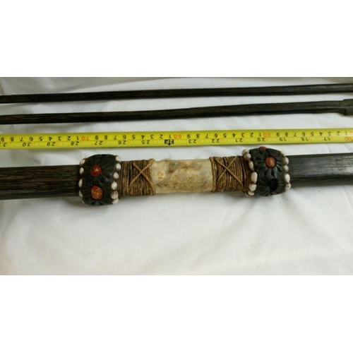 558 - A quantity of 1920's/30's ethnographic heavy palm wood tribal weapons including long bow, club spear... 