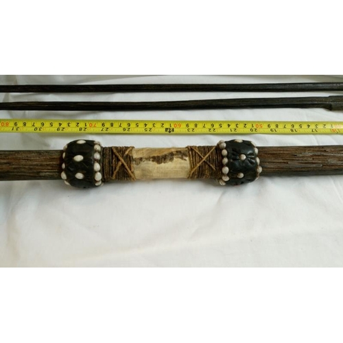 558 - A quantity of 1920's/30's ethnographic heavy palm wood tribal weapons including long bow, club spear... 