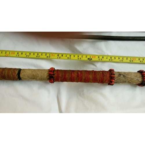 558 - A quantity of 1920's/30's ethnographic heavy palm wood tribal weapons including long bow, club spear... 