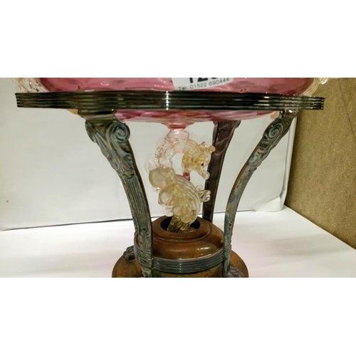 123 - A silver plated comport stand with cranberry glass bowl and surmounted with dragons (glass a/f)