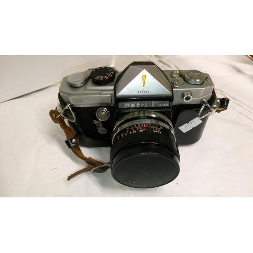 324 - A Kodak portrait brownie camera, a Petriflex camera with instruction book, a quantity of lenses, oth... 