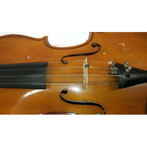 513 - A violin & 2 bows in case, label reads 'Piena student violin, model Antonius Stradivarius