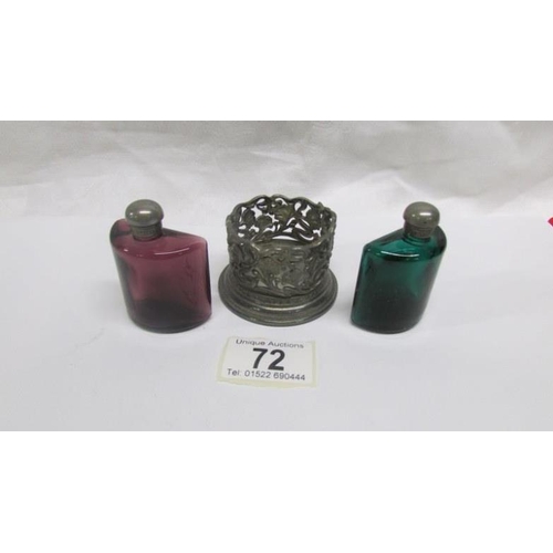 72 - A pair of coloured glass scent bottles in metal stand